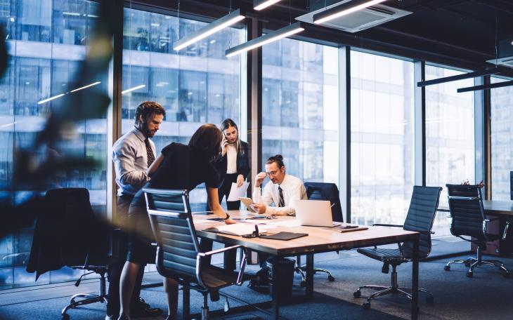 4 business people gathered around a table