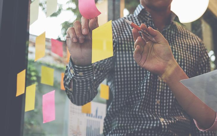 Post-it notes on a glass wall