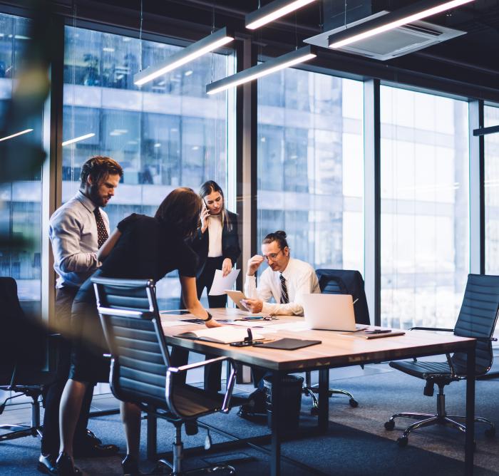 4 business people gathered around a table