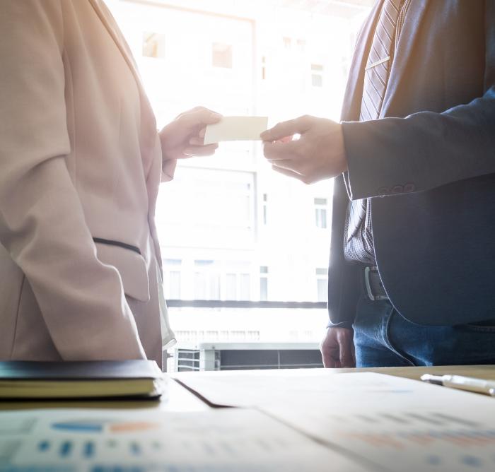 close up image of two people exchanging a note