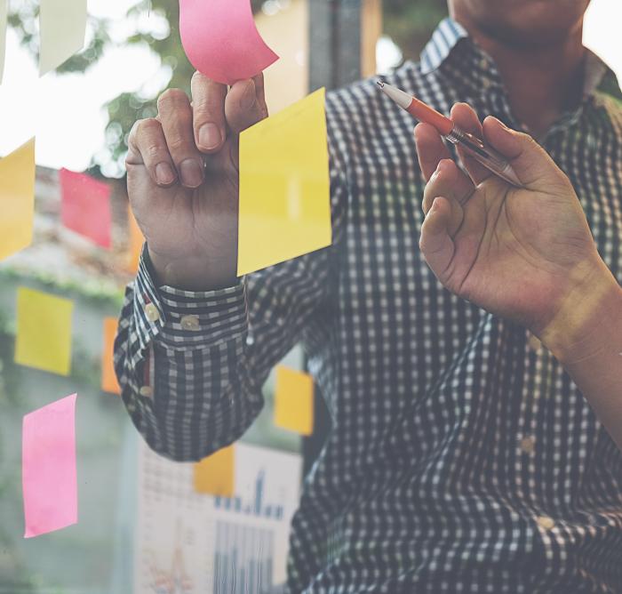 Post-it notes on a glass wall