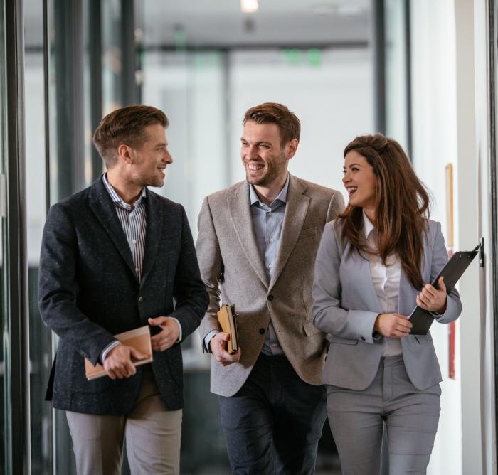 three professionals in mirrored corridor